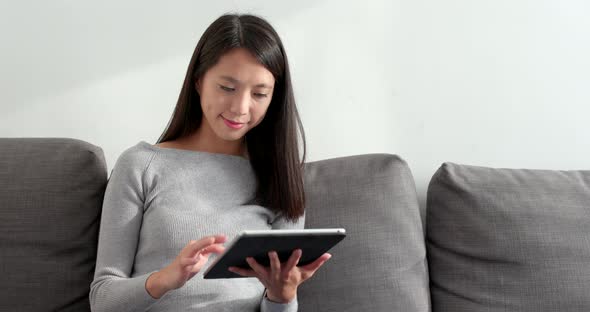 Woman watching tablet at home