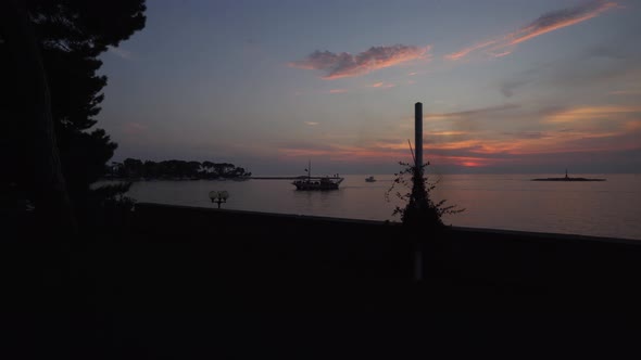 Silhouette of a ship sailing at sunset in Porec, Parenzo, Croatia