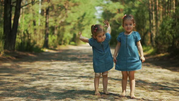 Girls are Walking on a Forest Road