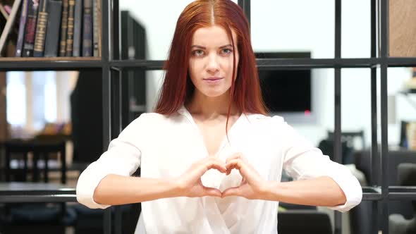 Handmade Heart Sign by Young Woman, Indoor