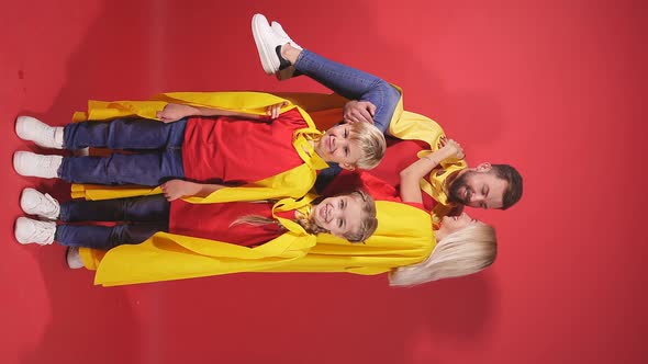 Goodlooking Parents Playing Superheroes with Children