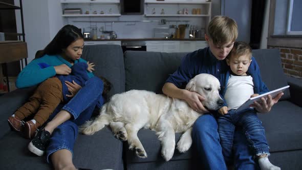 Diverse Family with Labrador Dog Relaxing at Home