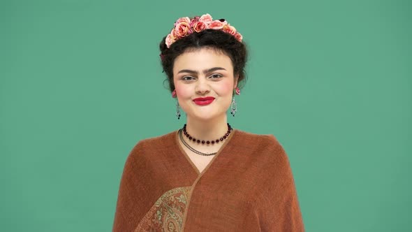 Fashion Portrait of Woman with Thick Eyebrows and Red Lips Makeup As Frida Kahlo Smiling Wearing