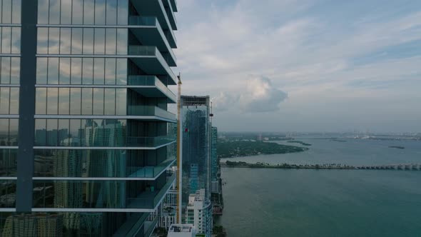 Forwards Fly Along Futuristic Residential Tower on Waterfront