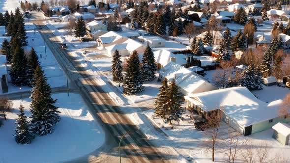 A quiet sunny afternoon in snowy small town streets.