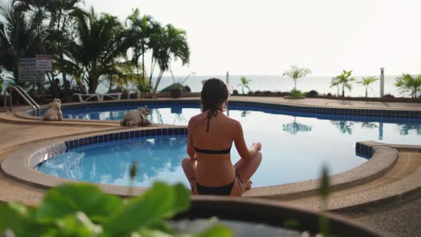 Thailand's Hotel Pool Woman Relaxing Asana Pose
