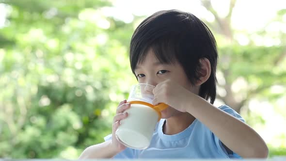 Cute Asian Child With A Glass Of Milk Slow Motion 