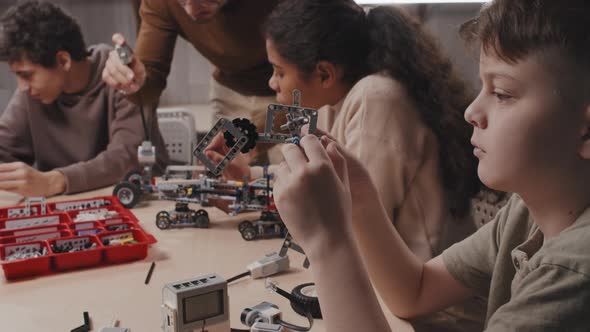 Young Teacher And Kids At Robotics Class