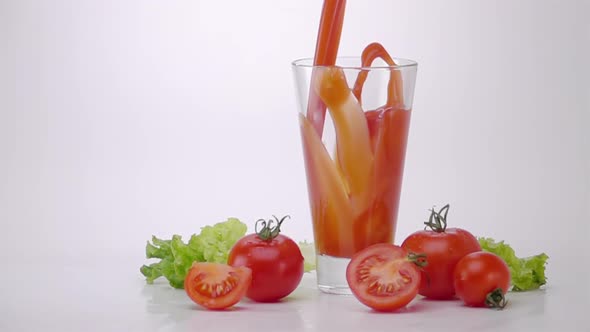 Pouring Tomato Juice Into Glass