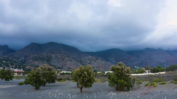 Aerial landscape of Greek Landscape. Clouds over Mountain. Drone Flying up near trees. 