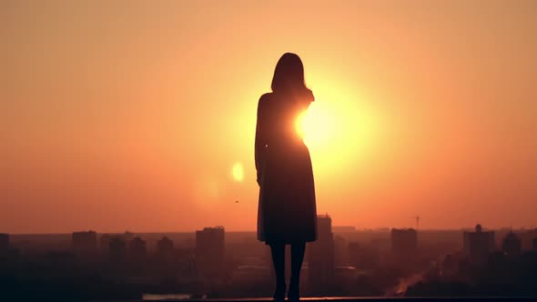 Back View Woman with Long Hair Looking on Sunrise