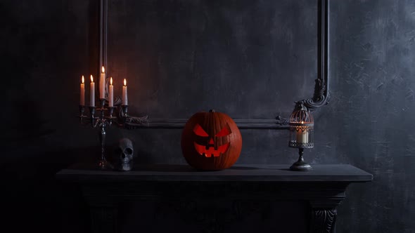 Scary laughing pumpkin and an old skull over the frightening gothic background.