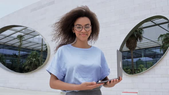 Fashionable Elegant Beautiful African American Young Woman with Curly Hair with Glasses Wearing a