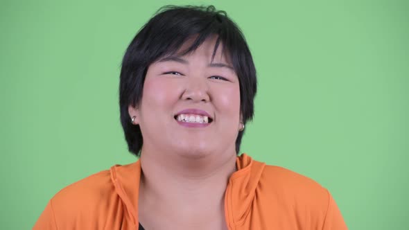 Face of Happy Young Overweight Asian Woman Laughing Ready for Gym