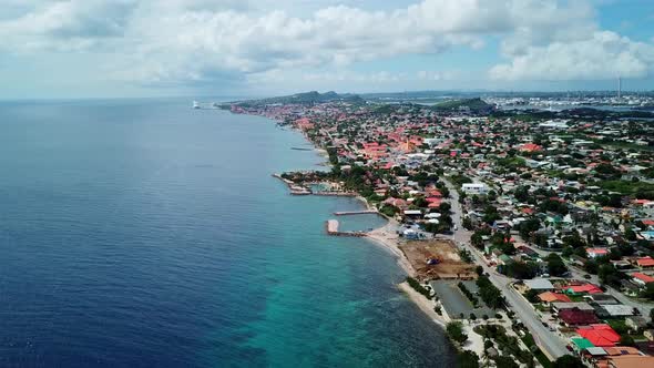 Aerial view dolly in Marie Pompoen Beach, Curacao, Dutch Caribbean island. Cruise ship and clouds on