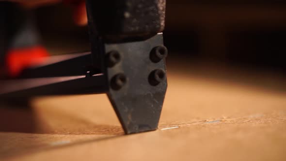 Close Up Shot of the Tool That Cuts the Chipboard, the Man Uses It To Work