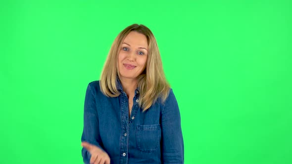 Portrait of Fair Woman Is Saying Oops and Shrugging, Flirting. Green Screen