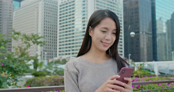 Woman use of smart phone in city