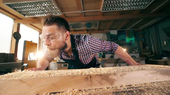 Slow Motion of the Shavings Getting Blown Off From the Wood