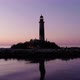 Old lighthouse on little island, cinematic orbiting shot after sunset - VideoHive Item for Sale