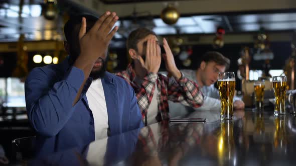 Multiracial Sport Fans Watching Tournament in Pub, Disappointed With Losing Game