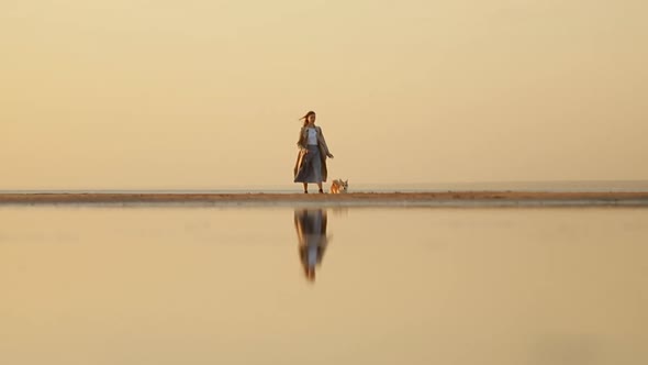 Woman and Pet Walk Along Beach at Sunset and Enjoy Scenery of Nature Outdoors Spbi