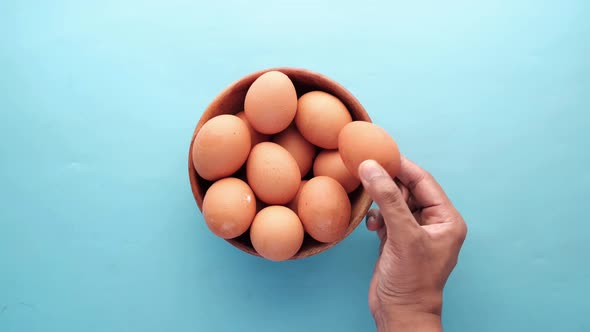 Hand Pick Eggs From a Plastic Case on Table