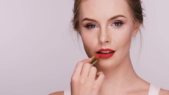 Nice Female Doing Make-up and Showing Heart with Lipstick