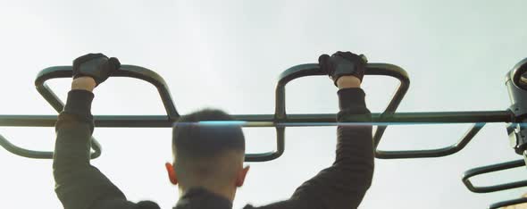 Man Doing Pull Ups on Workout Playground