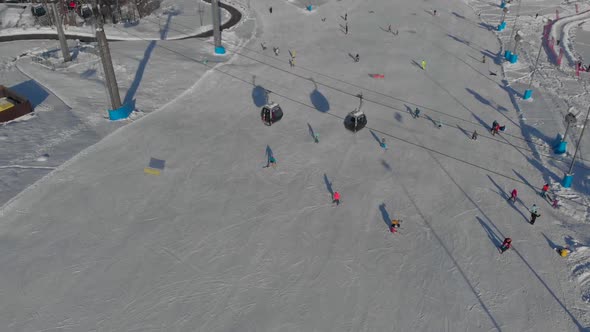 Sportsmen and Tourists Are Skiing and Snowboarding on Slope of Modern Ski Resort Aerial View