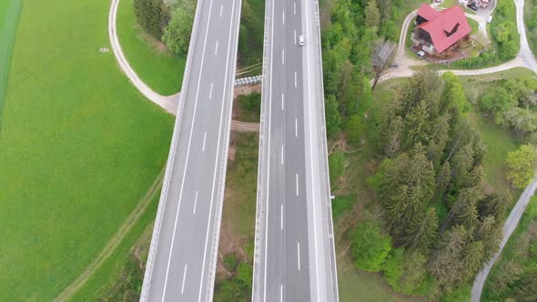 Aerial View of the Highway Viaduct on Concrete Pillars with Traffic in Mountains