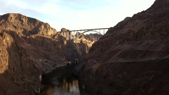 4K Aerial View of Hoover Dam and Colorado River Bypass Bridge from down in the Colorado River gorge