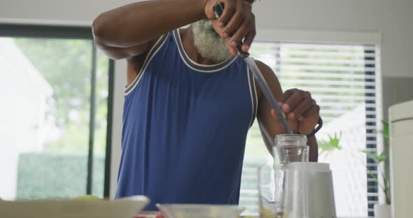 Video of african american senior man preparing smoothie