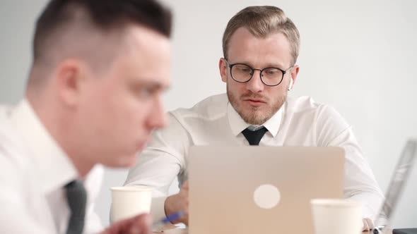 Two Male Partners Cooperate in Work for Project Analyzing Information. Collaborate Communication