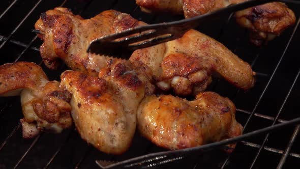 Chicken Wings on the Wooden Skewers are Frying and Roasting on the Grill