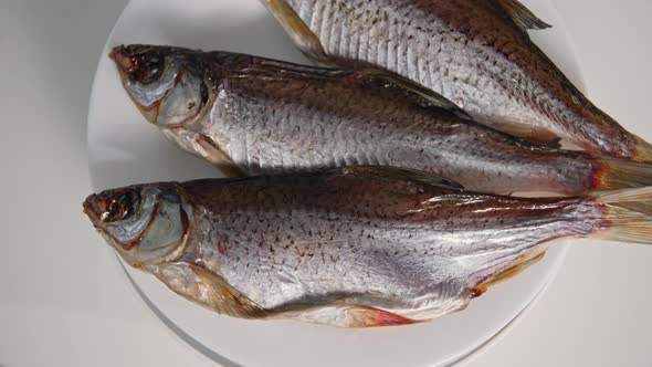 Healthy Foods Juicy Salted Fish on a Plate Spinning on a White Background