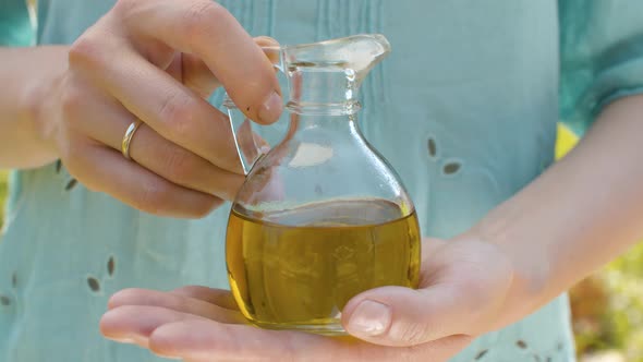 Olive Oil in Female Hands
