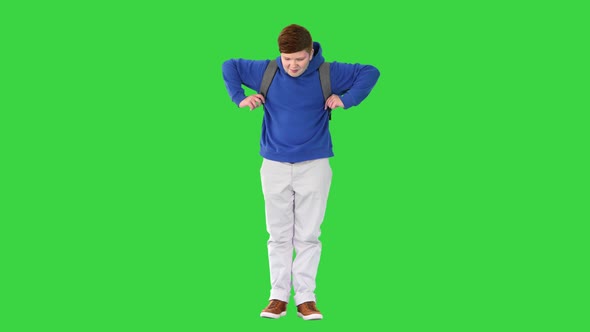 Young Student with Backpack Standing on a Green Screen Chroma Key