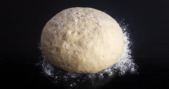 Bread Dough Rising on a Wooden Cutting Board