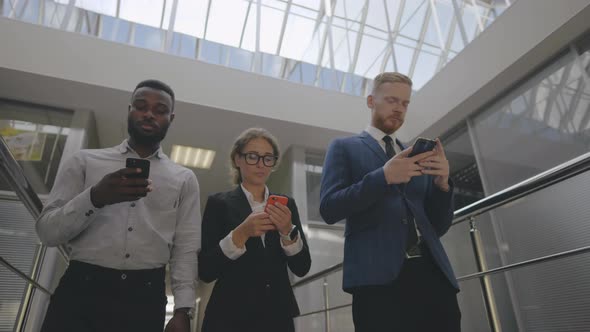 Multiethnic Businessman and Women Using Cellphone