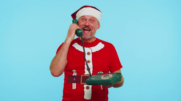 Funny Man in Christmas Tshirt Talking on Wired Vintage Telephone of 80s Says Hey you Call Me Back