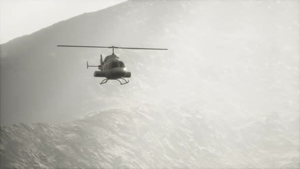 Extreme Slow Motion Flying Helicopter Near Mountains with Fog