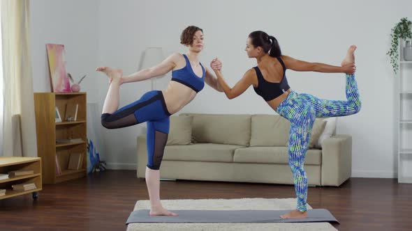 Female Partners Practicing Double Dancer Yoga Pose