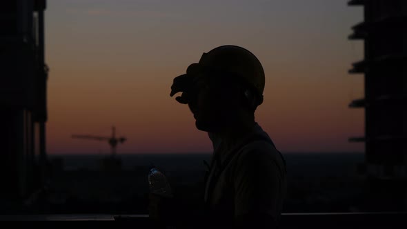 Builder Drinking From the Bottle.