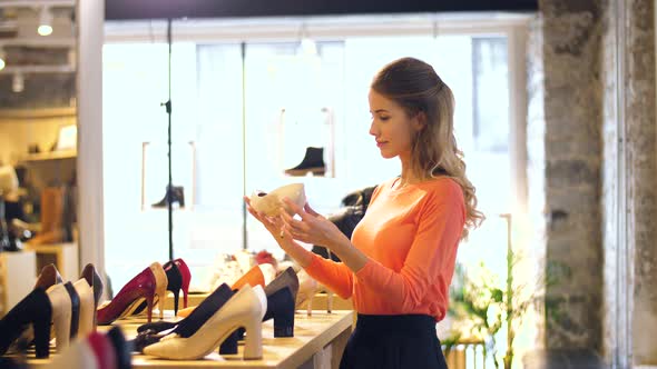 Happy Young Woman Choosing Shoes at Store 2