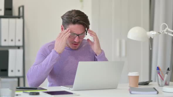 Middle Aged Man Angry on Laptop in Office