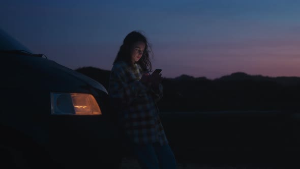 Vintage Focus on Girl Using Phone at Dark Night