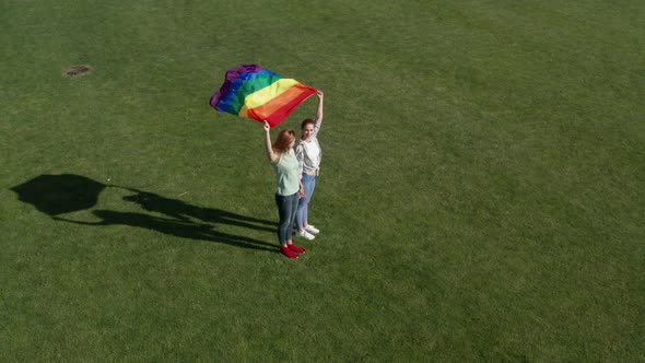 Aerial View of Lgbt Couple Holding Rainbow Flag