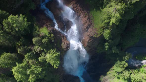 AERIAL LOWERING ROTATING to CLOSEUP, Iffigfall waterfall, Switzerland