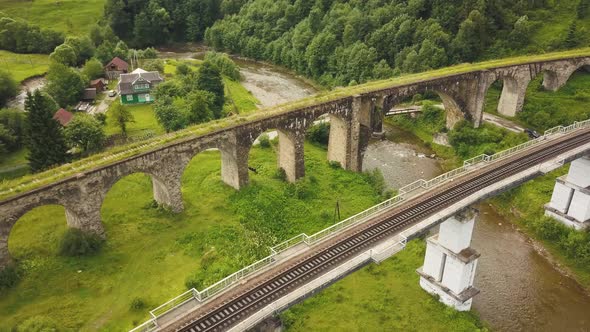 Old stone viaduct during summer.Historic arch bridge.Old Austrian bridge viaduct in Vorokhta village